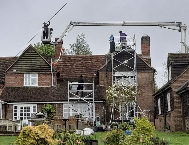 The Roof Moss Cleaners using cherry picker and scaffolding to clean roof safely and professionally in Stratford-upon-Avon, Warwickshire